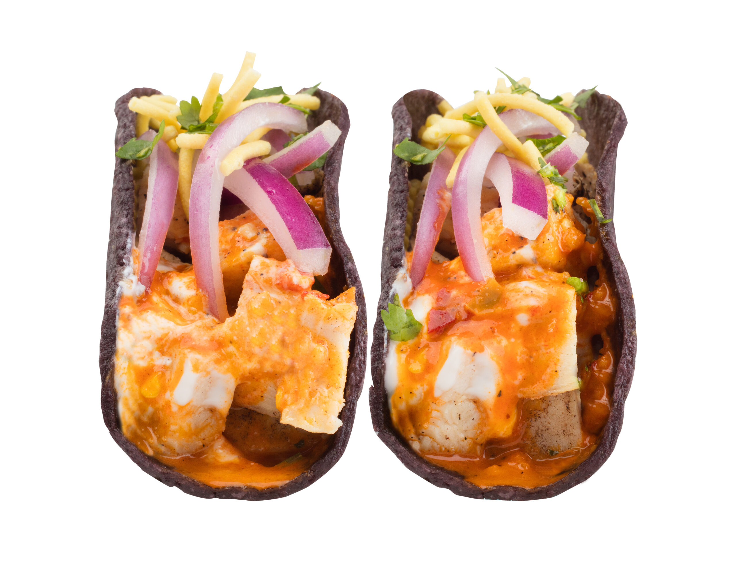 BangBang tacos in black corn shells at Balance Grille, filled with saucy grilled chicken, pickled red onions, cheese, and cilantro microgreens.