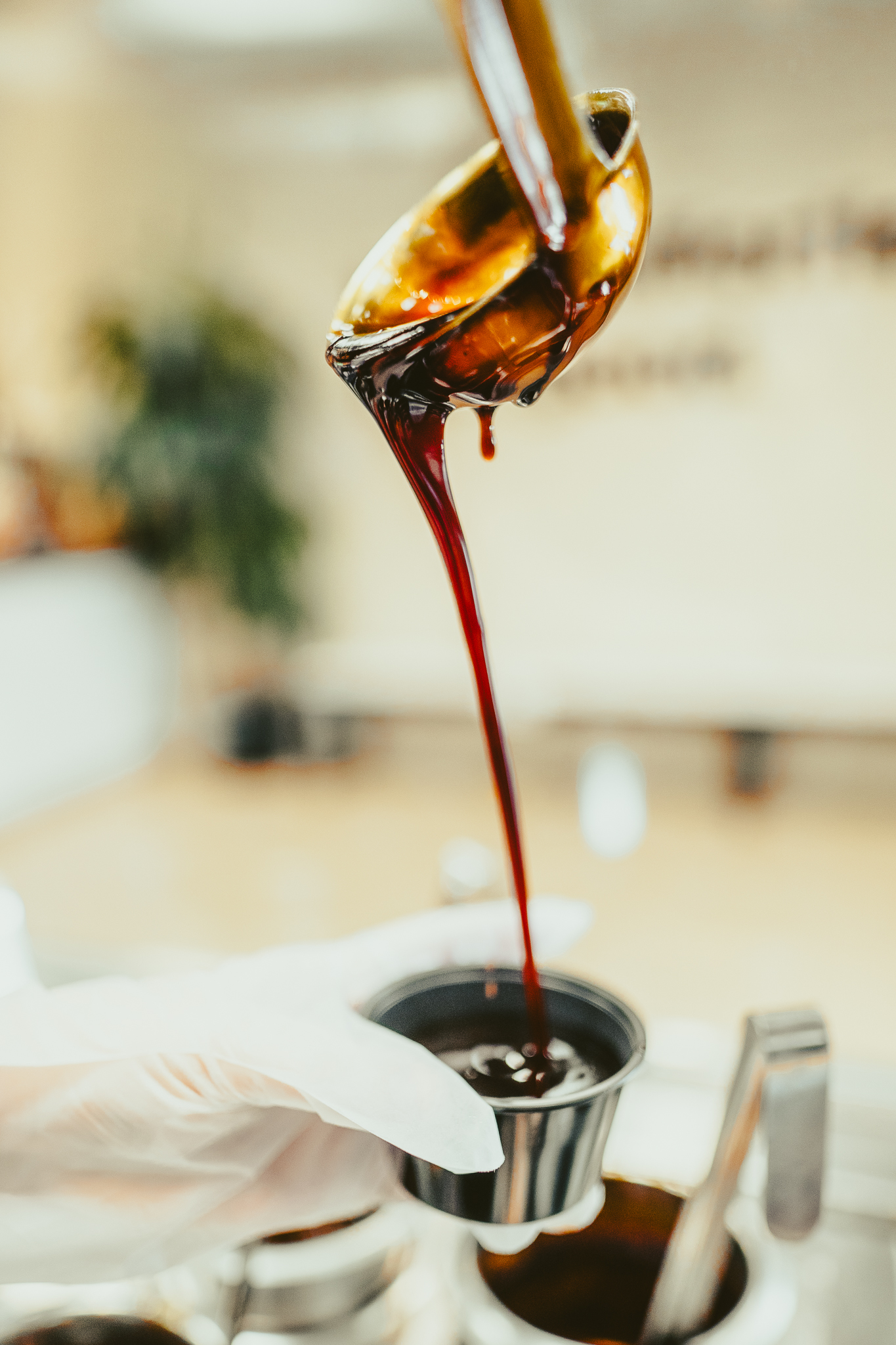 Thick house-made teriyaki sauce being poured into a to-go cup at Balance Grille, ready for dipping or drizzling.