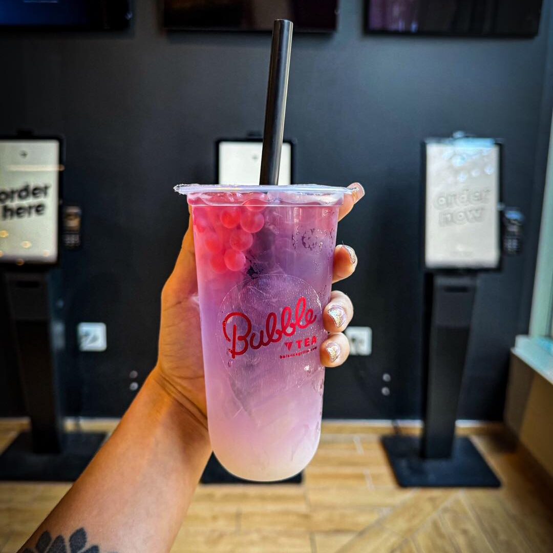 Colorful layered Balance Grille bubble tea topped with refreshing popping boba.