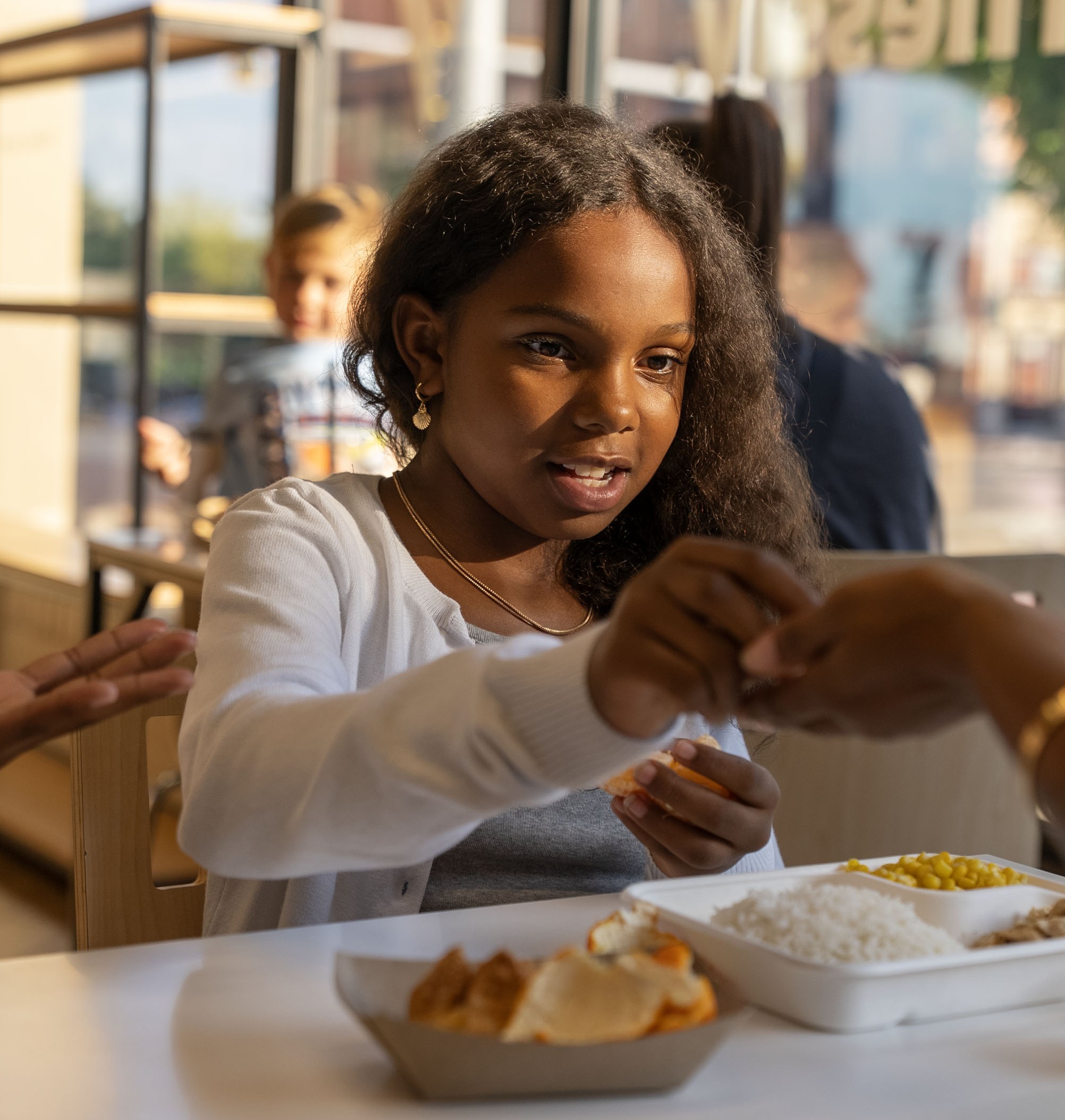A little girl sharing her meal with her family at Balance Grille, Ohio.