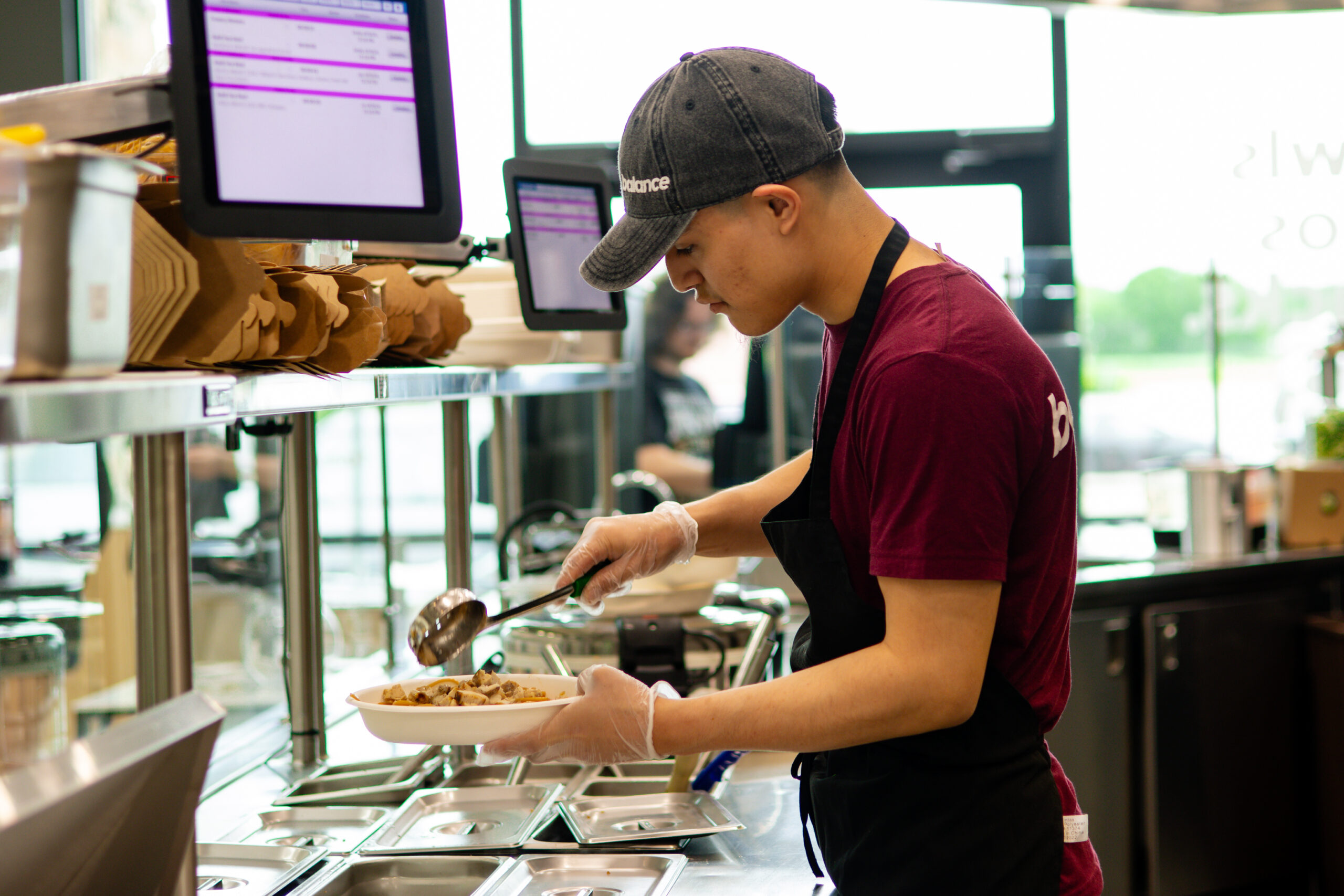 A chef at Balance Grille preparing a protein-rich bowl