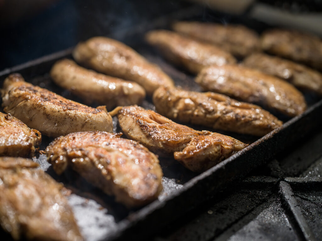 A grill at Balance Grille with fresh and juicy chicken breast.